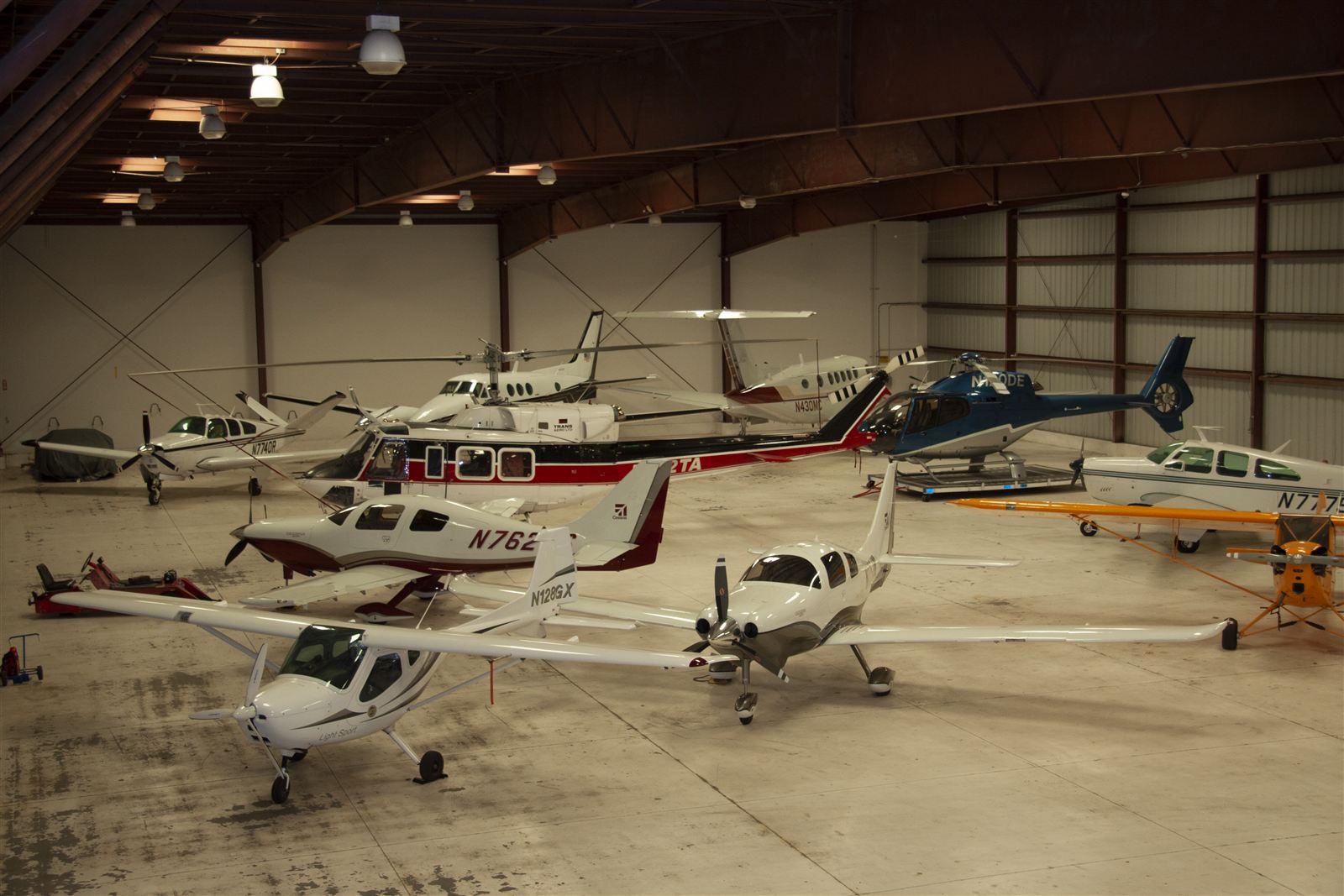 Completed executive hangar at Fullerton Municipal Airport with aircraft and helicopters parked inside